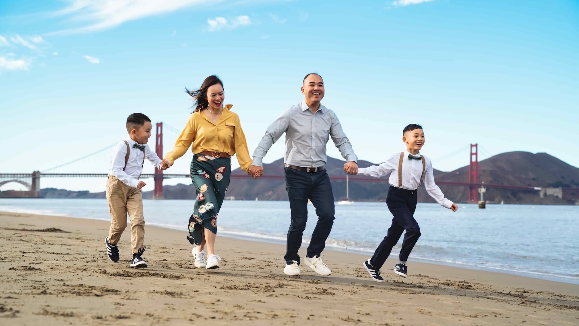 Family walking together through a sunlit golden field at sunset — Cocomel Portraits