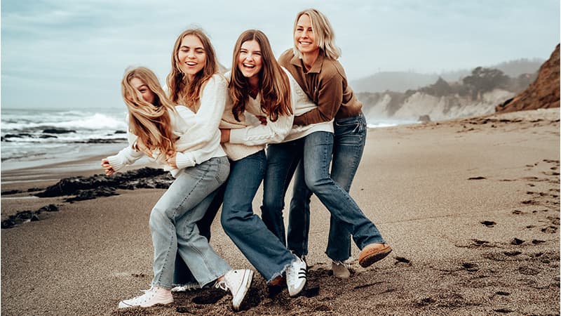 Close-up of parent holding child's hand during a portrait session — Cocomel Portraits