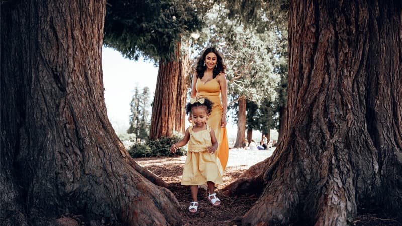 Behind the scenes of a newborn photography session with soft blankets and warm lighting